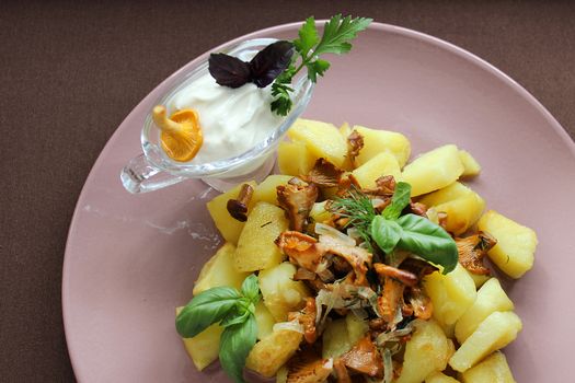 On the plate is a dish of fried mushrooms with fried potatoes and herbs .Texture or background