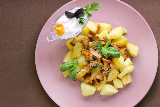 Country food fried potatoes with chanterelles and greens.Texture or background