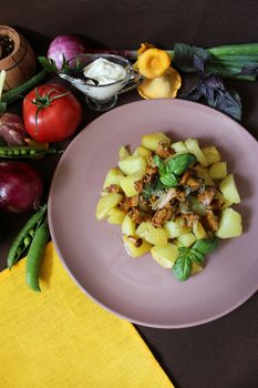 Fried potatoes with chanterelles and vegetables.Texture or background