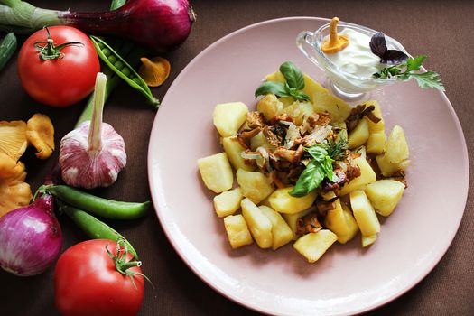 Fried potatoes with mushrooms with vegetables herbs and onions.Texture or background