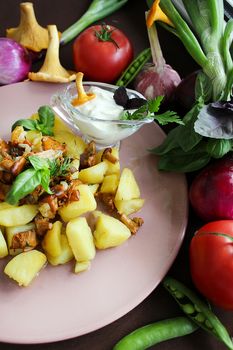 Russian dish potatoes with fried chanterelles onions and vegetables