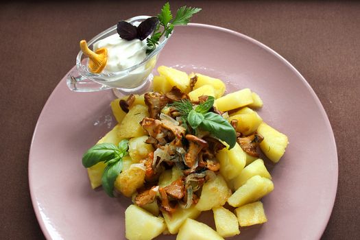Belarusian cuisine fried mushrooms with fried potatoes and herbs.Texture or background