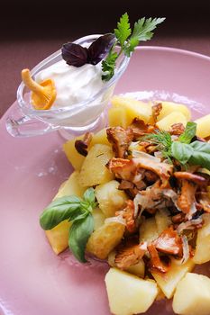 Belarusian cuisine fried mushrooms with fried potatoes and herbs.Texture or background
