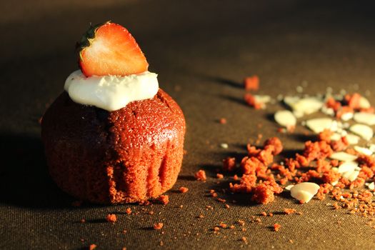 Chocolate cupcake decorated with a strawberry slice.Texture or background