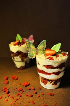 Strawberry ice cream with a cupcake and a slice of strawberry sprinkled with nuts.Texture or backgroun