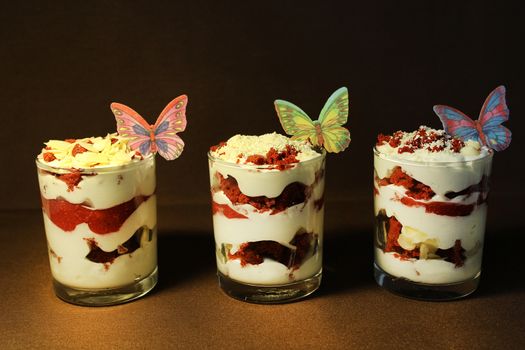 In a transparent container strawberry ice cream is decorated with a slice of strawberry