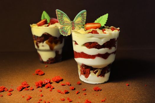 Vanilla ice cream is decorated with a slice of strawberry and white chocolate
