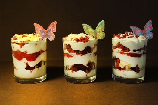 Strawberry ice cream is decorated with a slice of strawberry and white chocolate