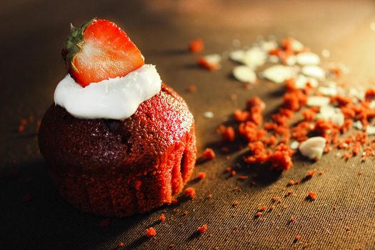 Strawberry cupcake is decorated with a strawberry slice .Texture or background