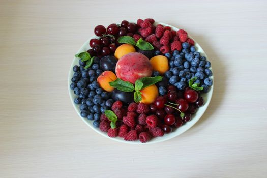 Berry mix on a plate on a white background.Texture or background
