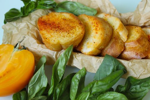 Close-up of toasted slices of baguette with greens spread out on paper