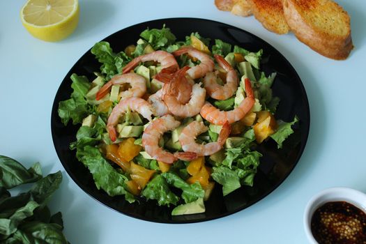 A dish of king prawns with lemon and herbs.Texture or background