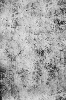 The scratched textured surface of the concrete wall is grey . Texture or background.