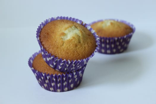 Three cupcakes in a blue wrapper .Texture or background
