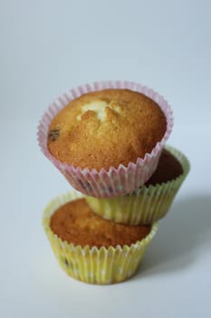 Homemade dessert for tea three cupcakes in a yellow wrapper .Texture or background