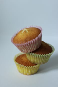 Sweet dessert three cupcakes is made up of a pyramid .Texture or background
