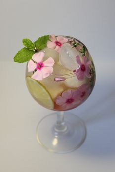 A glass of cold lemon juice with a leaf of green mint.Texture or background
