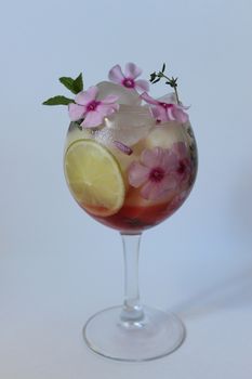 Cold fruit tea decorated with flower and mint.Texture or background