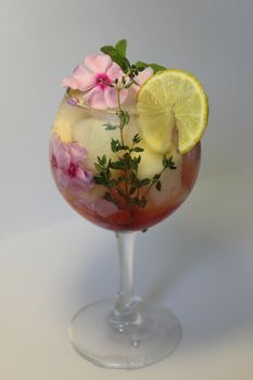 Fruit lemon tea with ice cubes and decorated with mint leaf close up