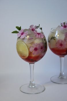 Cold fruit tea decorated with flower and mint.Texture or background
