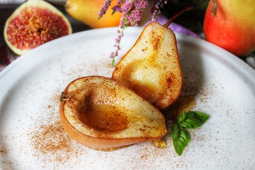 Autumn still life baked pears in syrup on a white plate.Texture or background