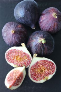 Fresh figs isolated on a dark background.Texture or background