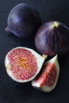 Juicy Fig slices on a dark background close-up.Texture or background