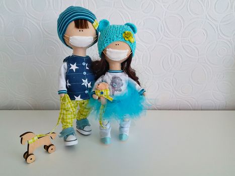 Handmade dolls with a medical mask on their face.Texture or background