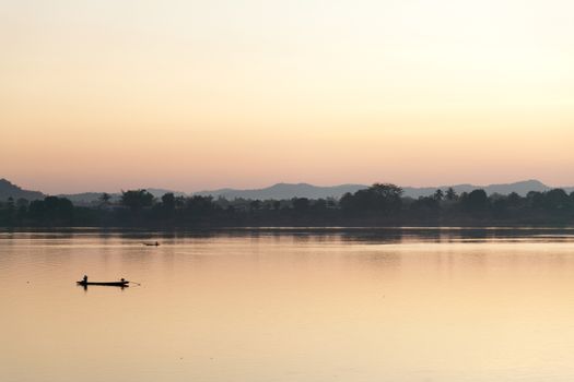 Muong Khong Laos 1/12/2012 Mekong river at dawn with golden sun and traditional fishing boats with nets . High quality photo