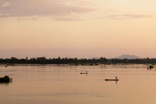 Muong Khong Laos 1/12/2012 Mekong river at dawn with golden sun and traditional fishing boats with nets . High quality photo