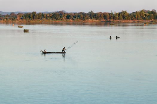 Muong Khong Laos 1/12/2012 Mekong river at sunset in blue hour and traditional fishing boats with nets . High quality photo