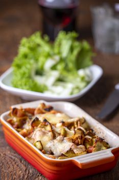 gratinated pasta on dark wood