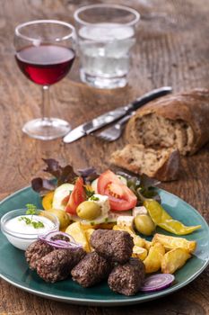 cevapcici on a plate with french fries