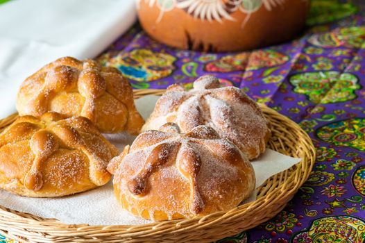 Traditional Mexican bread of the dead pan de muerto served with coffee from the pot cafe de olla, this bread is made around the day of the dead celebration and is often left on altars of remembrance