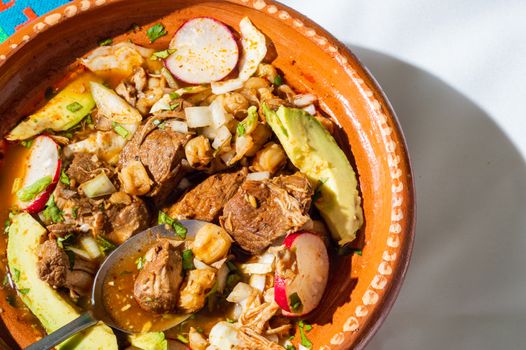 Red pozole, a traditional Mexican stew made with pork and hominy corn. In the Aztec heyday, this dish was made with human meat but the Spaniards ended the practice