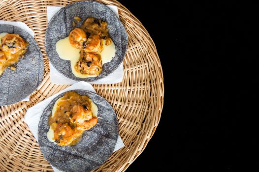 Tacos Gobernador (governors tacos), shrimp tacos cooked with spices and cheese, served on blue corn tortillas with avocado.