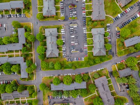 Car park in parking lot aerial view of suburban street of middle class suburban neighborhood with houses