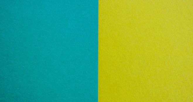 Blue-yellow background of matte suede, close-up. Velvety texture.