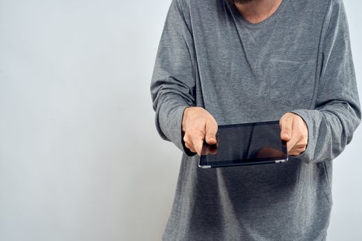 Man with tablet in hands technology internet lifestyle confident cropped view. High quality photo