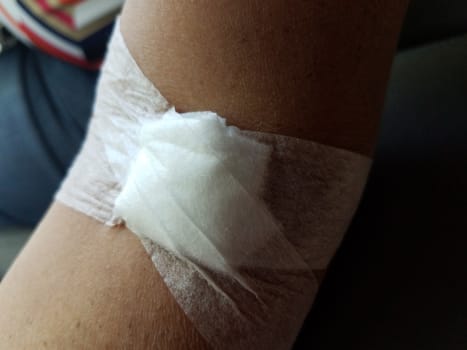 white cotton and bandage dressing on woman or female arm