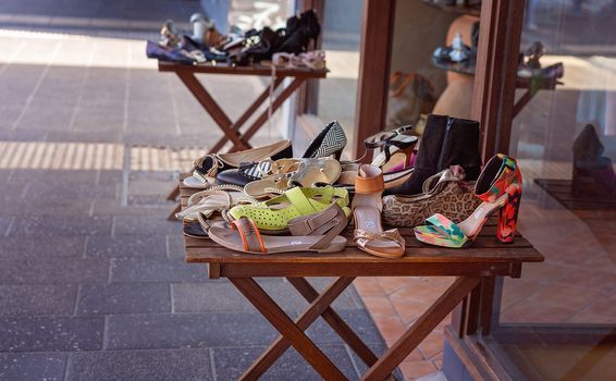 A table filled with fashionable shoes for sale outside a shop in a small Australian town