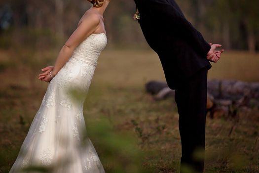 Bride and groom lean forward for a kiss after their marriage