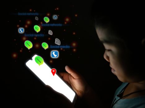 Boy holding The phone screen is blank And has a social media icon Put on a dark background. internet and communication concept.