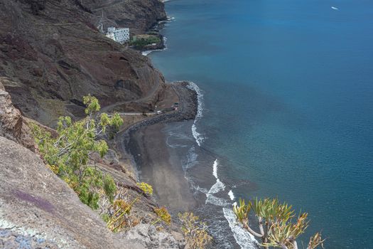 Seascape. Rocky coast with a black sand beach. Stock photo