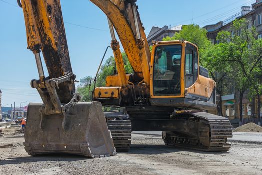 Large excavator for digging trenches during road repair