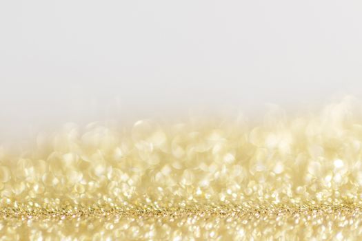 Abstract golden glitter background of shiny lights bokeh Christmas New year celebration luxury party