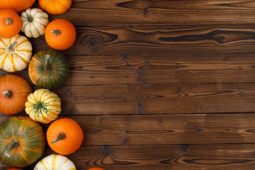 Many orange pumpkins on wooden background , Halloween concept , top view with copy space