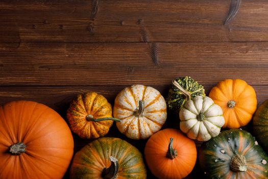 Many orange pumpkins on wooden background , Halloween concept , top view with copy space