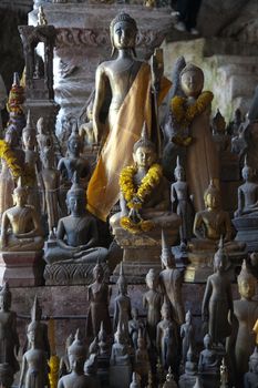 Ou Pak Caves Laos two caves on the west side of the Mekong river, with small and miniature Buddha statues in many different poses placed there for safe keeping and are frequently visited by tourists.. High quality photo