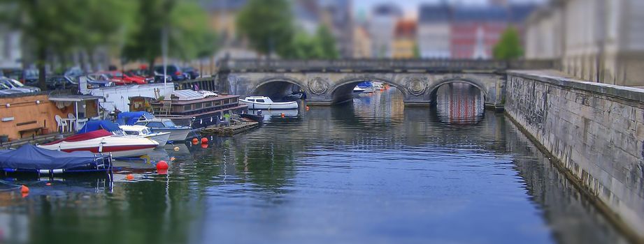 Cityscape with canal in Copenhagen, Denmark. Tilt–shift effect applied